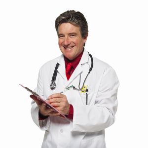 Close-up of doctor writing on clipboard