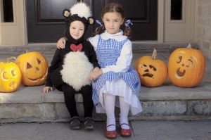 Brother and Sister Dressed for Halloween Sitting on a Step, Toronto, Ontario