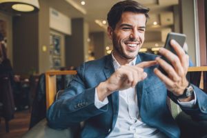 Businessman texting in cafe