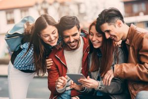 Friends using a tablet in the city