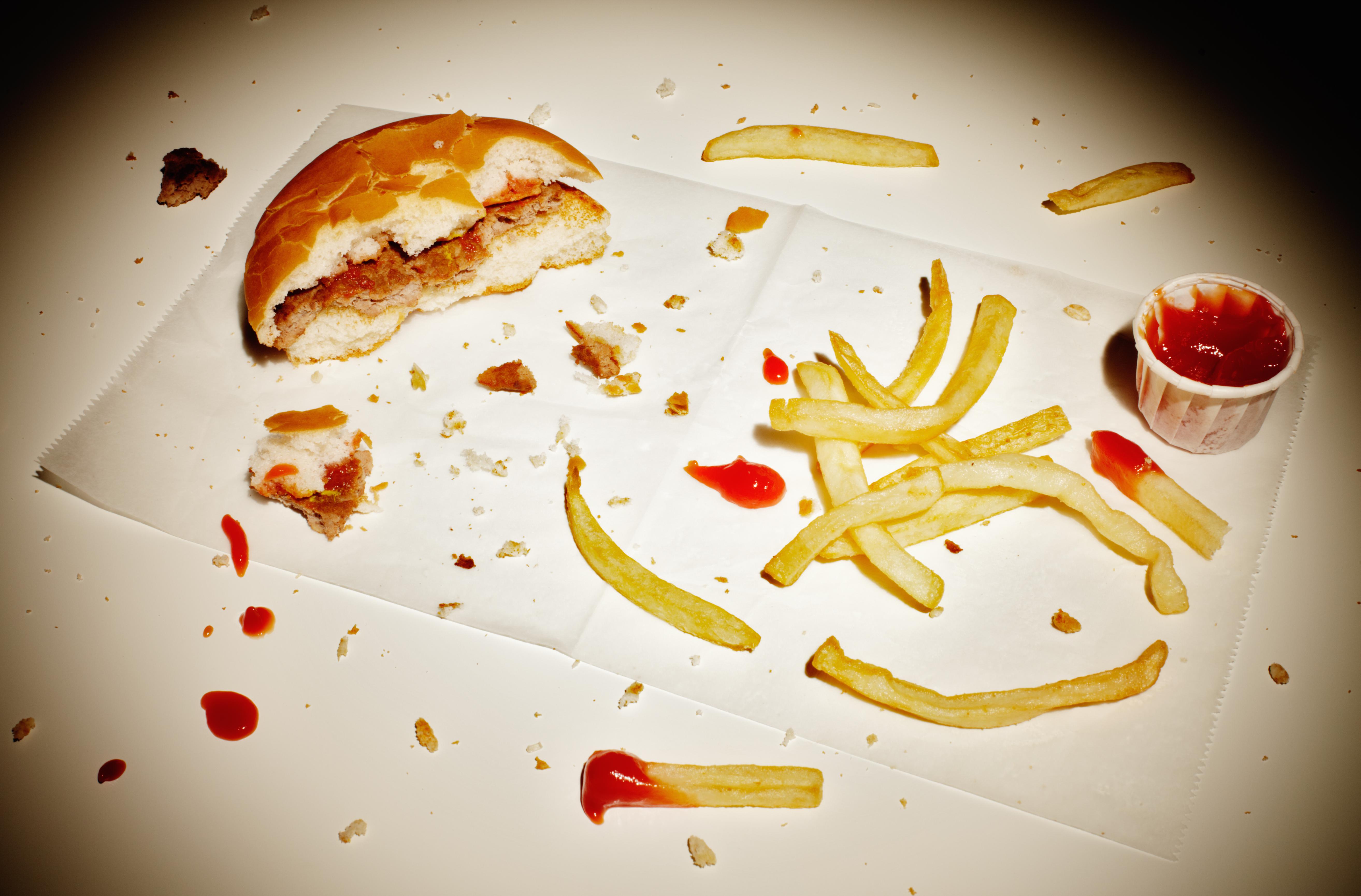 Half eaten burger and fries.