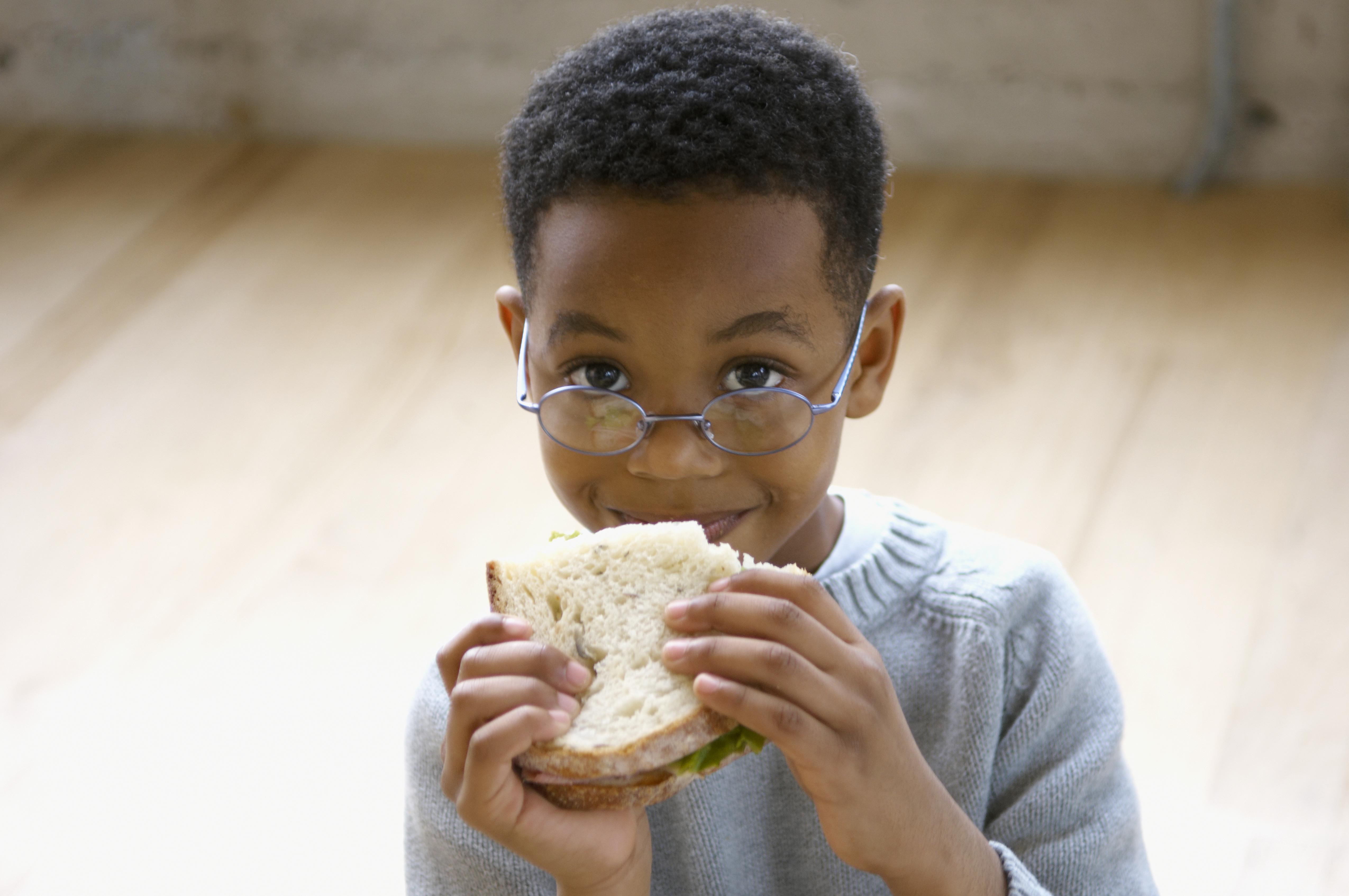 Young boy eating a sandwich