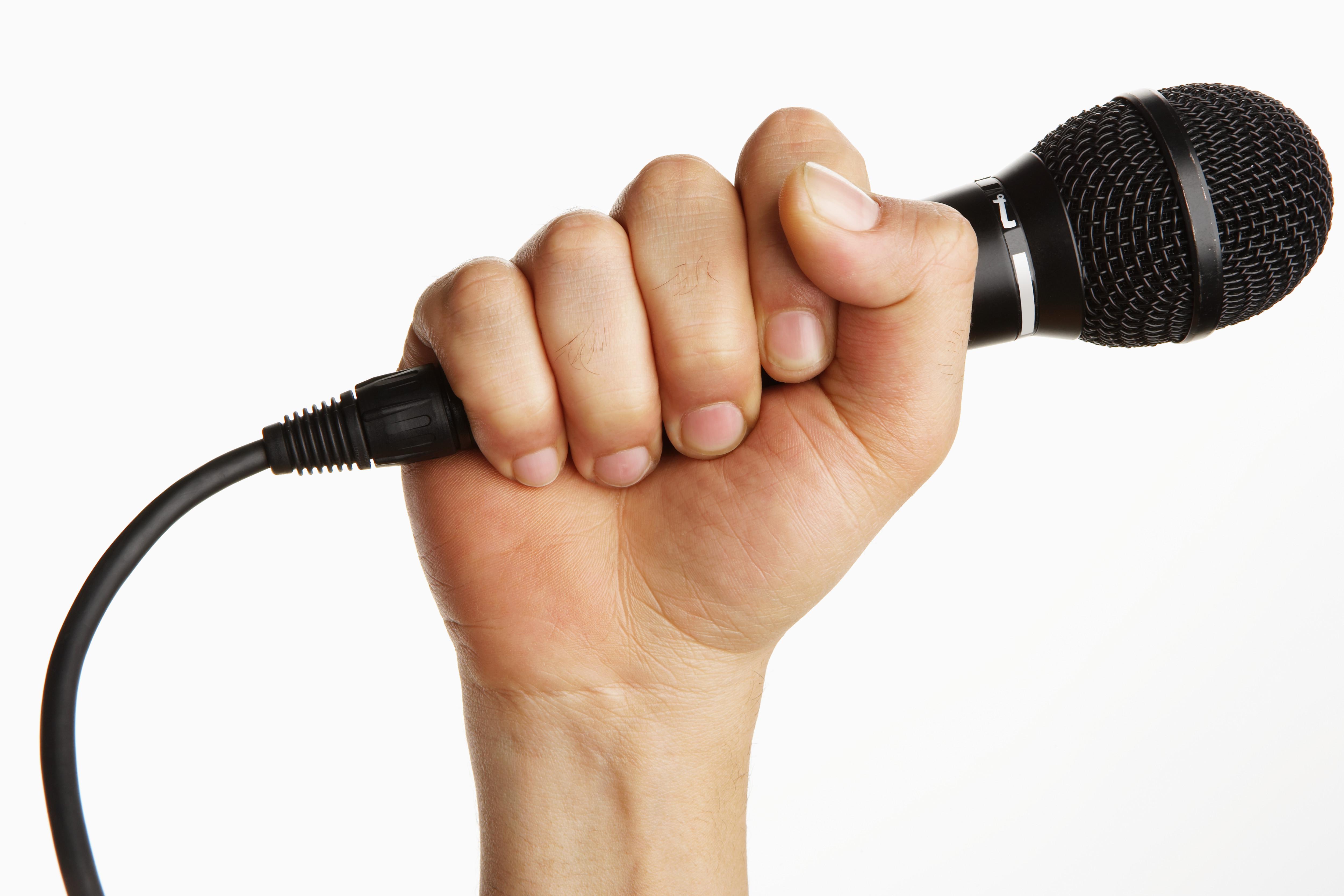 Man holding microphone (focus on microphone)