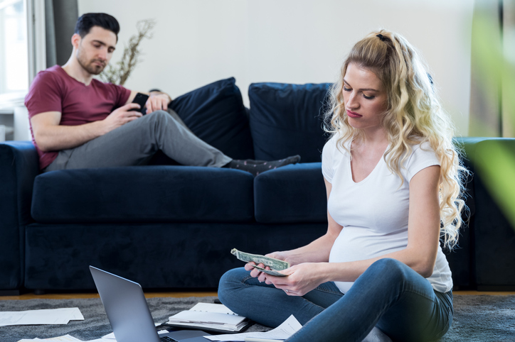 Pregnant woman is calculating family budget