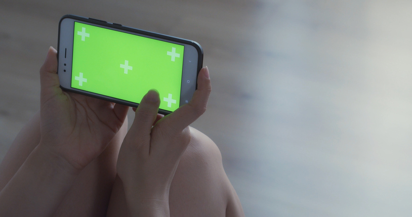 Cropped Hand Of Woman Using Mobile Phone At Home