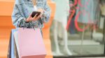 Midsection Of Woman Using Mobile Phone In City