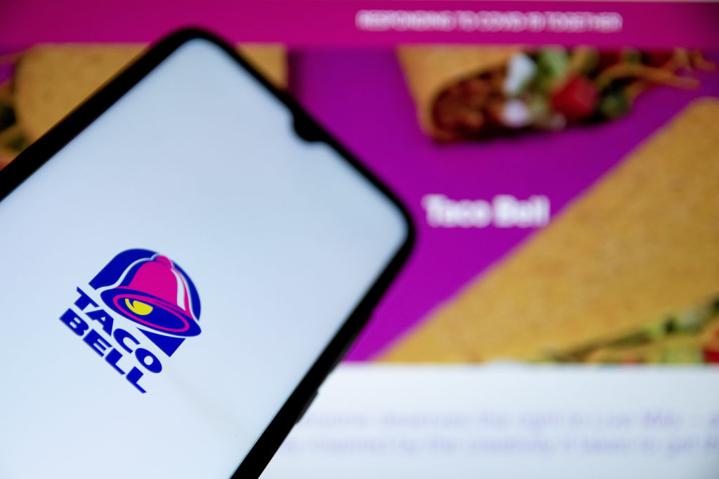 In this photo illustration a Taco Bell logo seen displayed...